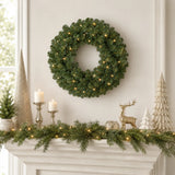 25-inch green pre-lit Christmas wreath with warm LED lights above a holiday mantel