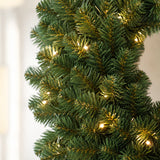 Close-up of dense PVC foliage and LED lights on the pre-lit Christmas wreath