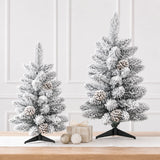 Two compact snow-flocked pinecone tabletop Christmas trees