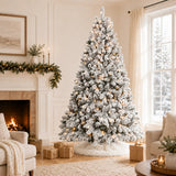 Warm-white pre-lit snow-flocked pinecone Christmas tree by a fireplace