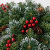Close-up of mixed PVC and pine needle foliage, red berries and pinecones