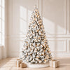 Pre-lit snow-flocked PVC artificial Christmas tree in a bright room