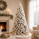 Full pre-lit snow-flocked Christmas tree in a warm holiday room