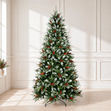 Snow-kissed artificial Christmas tree with red berries and pinecones in a bright room