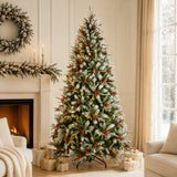 Pre-lit snow-kissed Christmas tree with warm white lights beside a fireplace
