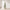 Pre-lit snow-flocked artificial Christmas tree with warm white lights in a bright room