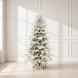 Pre-lit snow-flocked artificial Christmas tree with warm white lights in a bright room