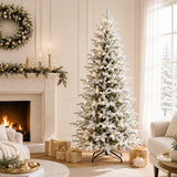 Full snow-flocked Christmas tree with integrated warm lights beside a holiday fireplace