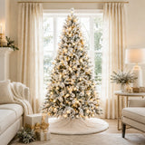 Pre-lit snow-flocked Christmas tree displayed in a bright living room