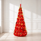 Pre-lit red pop-up Christmas tree displayed in a bright living room